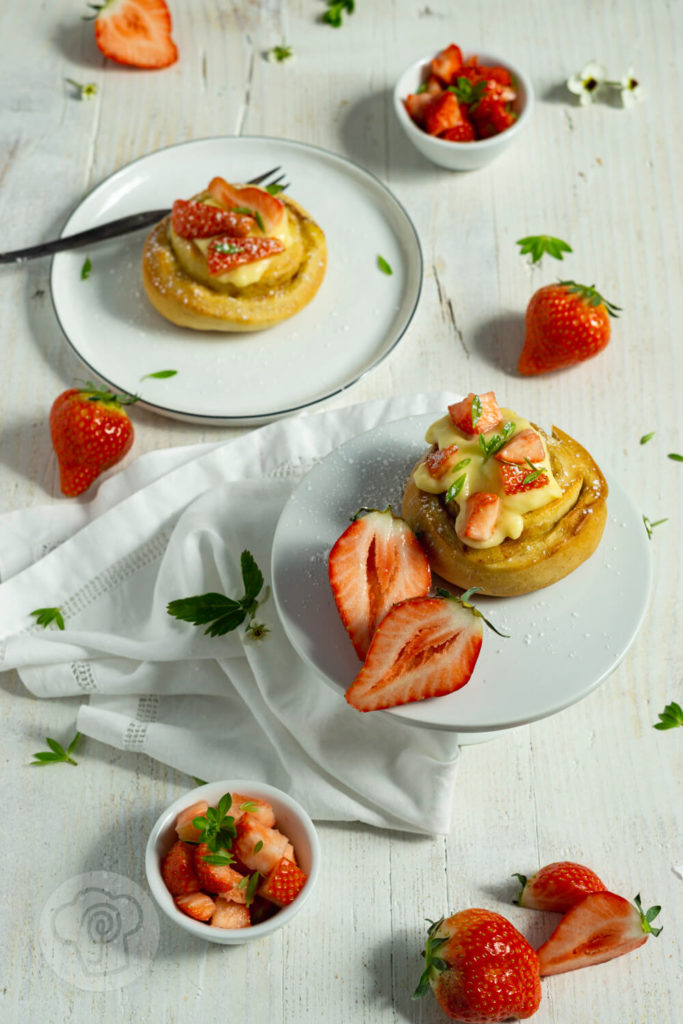 Rezept zum Backen. Fluffige Puddingschnecken aus Hefeteig mit Vanille und Erdbeeren. Dazu ein leckeres Erdbeerragout mit Waldmeister. Perfekt zu Muttertag oder einfach so. Der Teig kann am Vorabend zubereitet werden und dann im Kühlschrank über Nacht gehen. Küchentraum & Purzelbaum