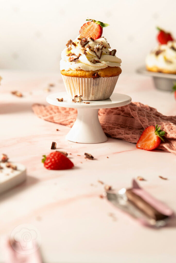 Yogurette Muffins mit Sahnetopping, Erdbeeren und Schokolade auf der Etagere